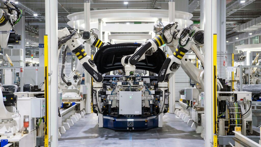 A car being assembled by robots in a factory